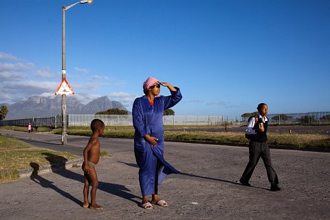 Debby Lottering and her son, Meezie, watch as Meezie's older brother walks to school. In August 2013 all schools in Manenberg were closed after a spike in gang violence killed nearly 50 people. 2014.