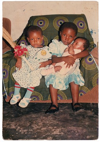 Faradja, Rebecca and Daniel Katembera. From a Katembera family photo album. Photographer unknown. Kinshasa, D.R.C., 1990.