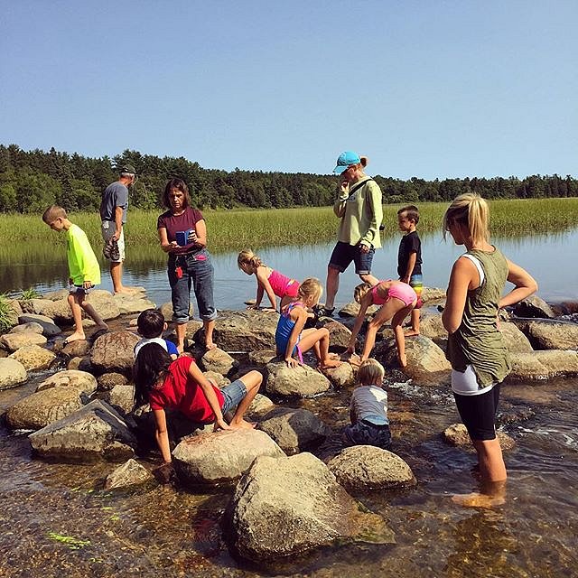 Day trip to Itasca State Park, headwaters of the mighty Mississippi River. Families cross the rocks marking the start of the Mississippi River. 