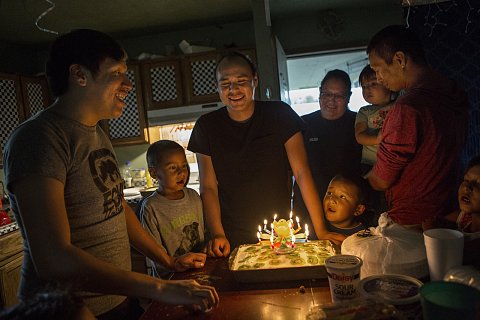 Danny Grassrope, left, and his family sing happy birthday to Joseph White Eyes, center, on his 24th birthday.<br> Lower Brule, South Dakota. June 8, 2019.